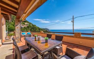 a patio with a table and chairs and the ocean at Vistamar in Canyamel