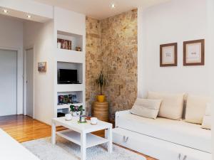 a living room with a white couch and a table at Charming Apartment in Zagreb