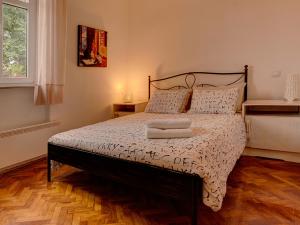 a bedroom with a bed with a wooden floor at Charming Apartment in Zagreb