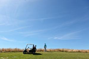 a man standing in a field with a golf cart at Palmares Beach House Hotel - Adults Only in Lagos