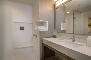 a bathroom with a sink and a mirror at Courtyard by Marriott London in London