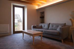 a living room with a couch and a coffee table at Al Cortiletto Apartments in Gardone Riviera