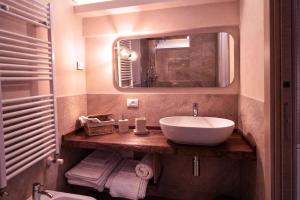 a bathroom with a sink and a mirror at Al Cortiletto Apartments in Gardone Riviera