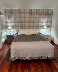 a bedroom with a large bed with two night stands at El Chalet Del Golf in Urturi