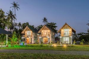 a large house with lights on the lawn at Madiha Beach Resort in Matara