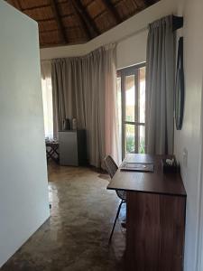 an office with a wooden desk in a room with windows at Afrikhaya Guest House in St Lucia