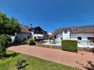 a house with a brick driveway and a pool at Apartmány Močovice in Močovice