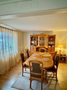 a dining room with a wooden table and chairs at Fjord Haven in Gryllefjord