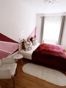 a bedroom with a large bed and a couch at Familienfreundliche Fewo mit Garten in Schwarz
