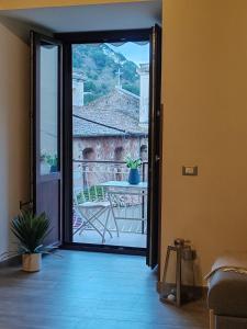 a room with a door open to a balcony with a table at Lissy Casa Vacanze in Lamezia Terme