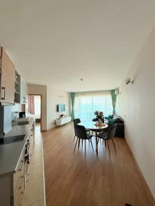 a kitchen and dining room with a table and chairs at Apartment Sunrise Pomorie in Pomorie
