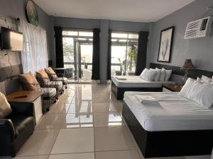 a living room with two beds and a couch at Pio's Place Hidden Resort in Namonitan
