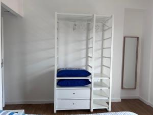 a white bunk bed with blue pillows in it at A casa di Chiara in Isca sullo Ionio