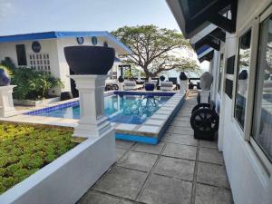 a swimming pool next to a house at Pio's Place Hidden Resort in Namonitan +8 photos