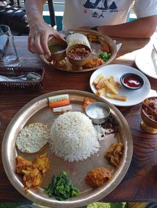 a table with plates of food on a table at Fast food in Lukla