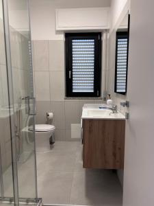 a bathroom with a sink and a toilet at A casa di Chiara in Isca sullo Ionio +11 photos