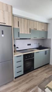 a kitchen with blue cabinets and a black oven at Casa TataDora in Arucas