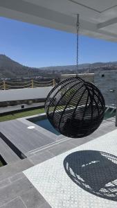 a metal swing hanging from the roof of a house at Casa TataDora in Arucas