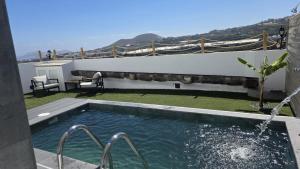 a swimming pool with a view of the ocean at Casa TataDora in Arucas