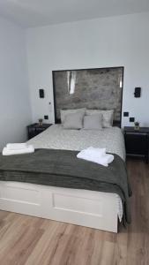 a bedroom with a large bed with a wooden floor at Casa TataDora in Arucas +4 photos