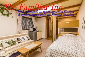 a room with a bed and a table in it at The Familiar Inn ー 2 min walk to subway, 5 min to Namba Station in Osaka