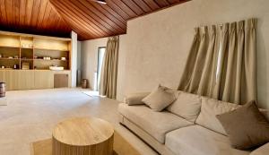 a living room with a couch and a table at Tulum Villa Resort Koh Samui in Bophut
