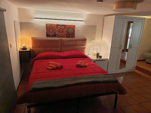 a bedroom with a red bed with red sheets at Dimora Agata 21 in Ostuni