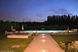 a swimming pool in a yard at night at Bed & Breakfast Case Osti in Castel Maggiore