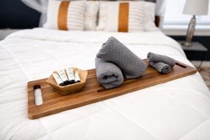 a tray with towels and cosmetics on a bed at Cozy Studio Downtown Detroit in Detroit
