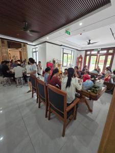 a group of people sitting in chairs in a room at Tam Coc Natura Hotel in Văn Lâm