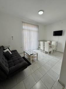 a living room with a couch and a table at Vila Cirkovic - 200m od mermernog setalista in Soko Banja