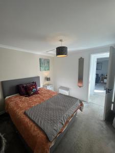 a bedroom with a large bed in a room at Silvermead stables Own access studios near Plymouth Life Centre FREE parking in Plymouth