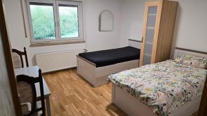 a small bedroom with a bed and a window at Bright 3-Bedroom Apartment in Hechelmannskirchen