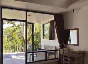 a room with a balcony with a sliding glass door at Gumi Ayu EcoStay in Munduk +106 photos