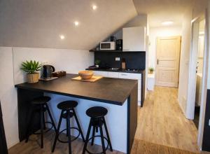 a kitchen with two bar stools and a counter top at Apartments Poldi in Bled