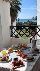 a table with food on it with a view of the ocean at Vitamin Sea in Zahara de los Atunes