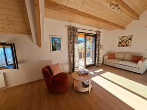a living room with a couch and a table at Chalet du Mont Granier in Apremont