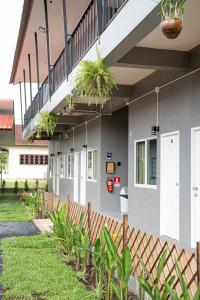 a house with potted plants on the side of it at Palai House in Ban Na Bon +8 photos