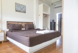 a bedroom with a large bed in a room at Palai House in Ban Na Bon