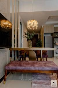 a living room with a dining room table with a bench at Luxury Trizen Aki Apartments in Colombo