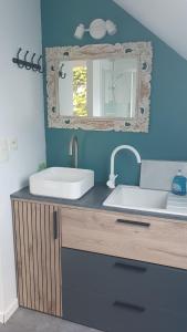 a bathroom with a sink and a mirror at Evned Kelien in Theix +15 photos