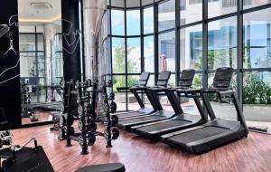 a row of treadmills in a gym with windows at Luxury Trizen Aki Apartments in Colombo