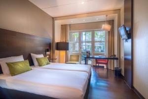 Postel nebo postele na pokoji v ubytování Golden Tulip Ampt van Nijkerk