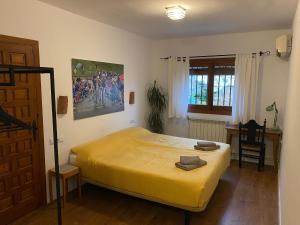 a bedroom with a large yellow bed in a room at La Ventera - Casa Rural in Gualchos