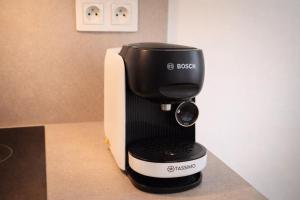 a black and white coffee maker sitting on a counter at VIRIDIS Apartment in Františkovy Lázně +12 photos