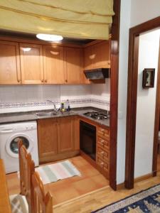 a kitchen with a sink and a stove top oven at Residencial Valle de Benasque in Benasque +22 photos