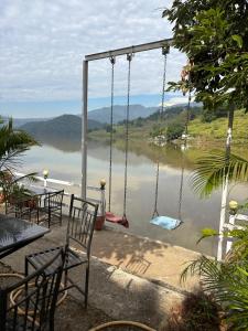 a swing with a view of a body of water at Riverside guest house in Besisahar