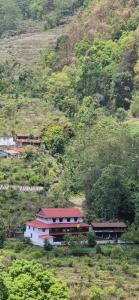 a building on the side of a hill at Riverside guest house in Besisahar