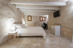 a bedroom with a bed and a tv on the wall at Castello Room & Spa in Cagliari