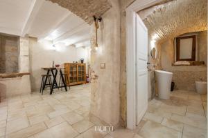 a large room with a stone wall and a doorway at Castello Room & Spa in Cagliari +24 photos